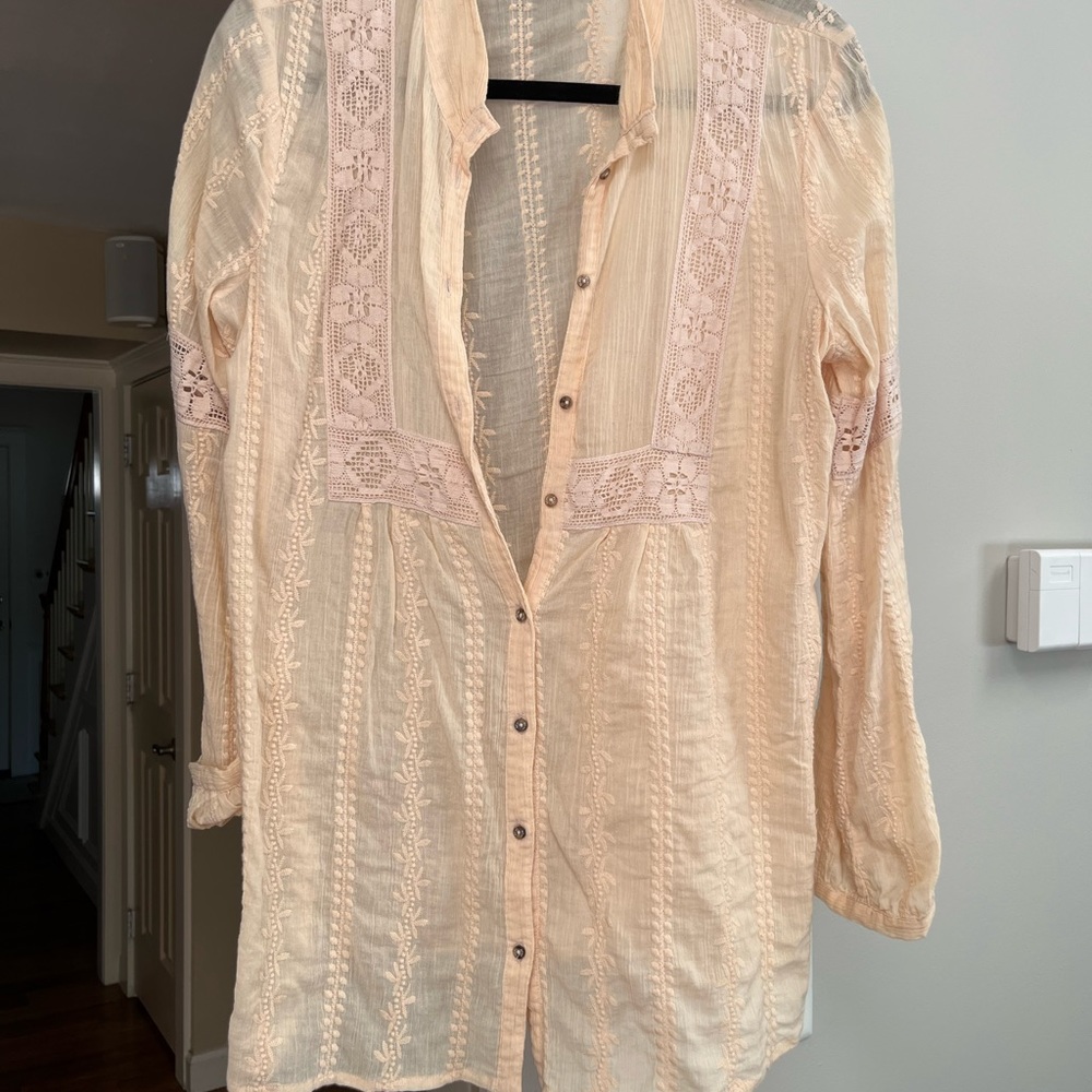 Pretty feminine blouse beautiful detail .  Light peach/cream  color . Medium